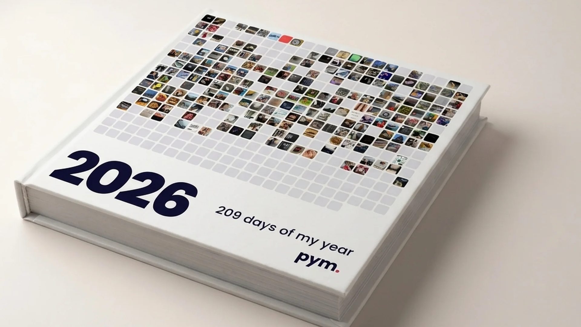 A printed PYM 2026 yearbook with the 365 mosaic cover: one small photo for every day kept