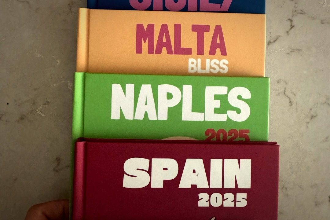 A stack of printed PYM travel books: Spain, Naples, Malta, Sicily